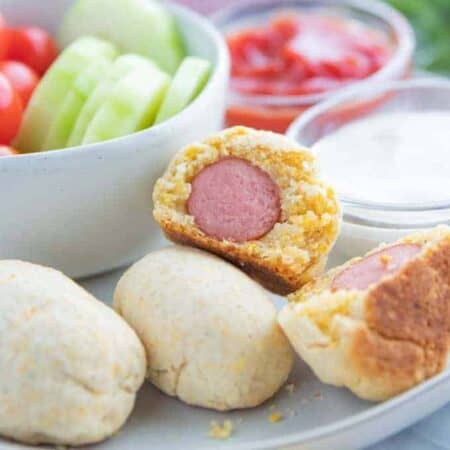 A plate full of Corn dogs