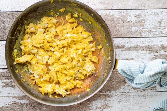 a skillet with scambled eggs