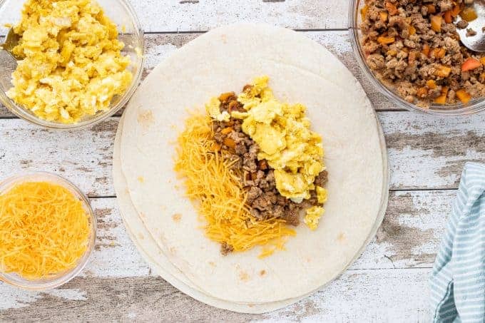  a burrito shell with eggs, beef and cheese