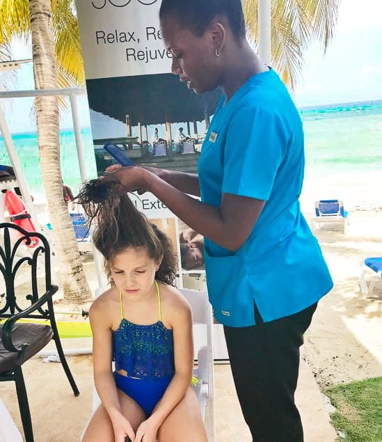 Girl getting braids at hilton rose hall jamaica