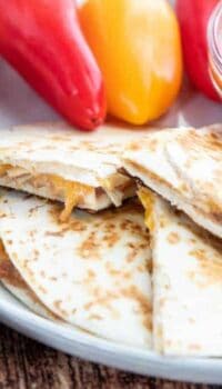 A quesadilla cut in half on a plate