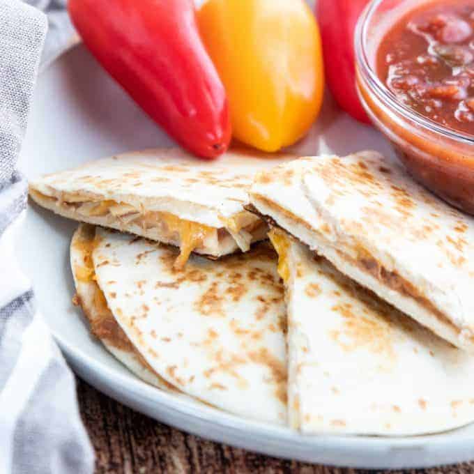 A quesadilla cut in half on a plate