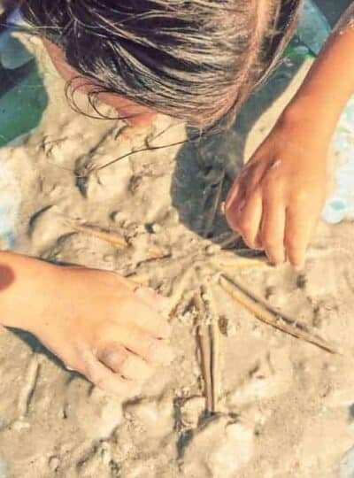 Girl uncovering a star fish on Sanibel Island Florida
