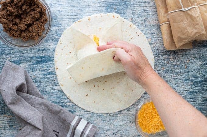 folding a tortilla for a burrito