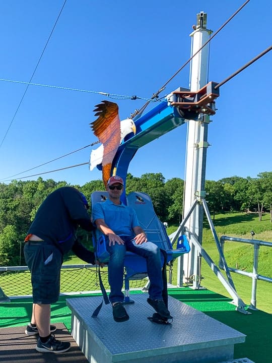 things to do in galena il showcasing a man getting onto the soaring Eagle Zipline