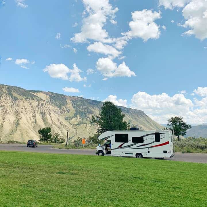 A view of a rental rv in front of mountains in Mammoth hot spring in Yellowstone national parl.