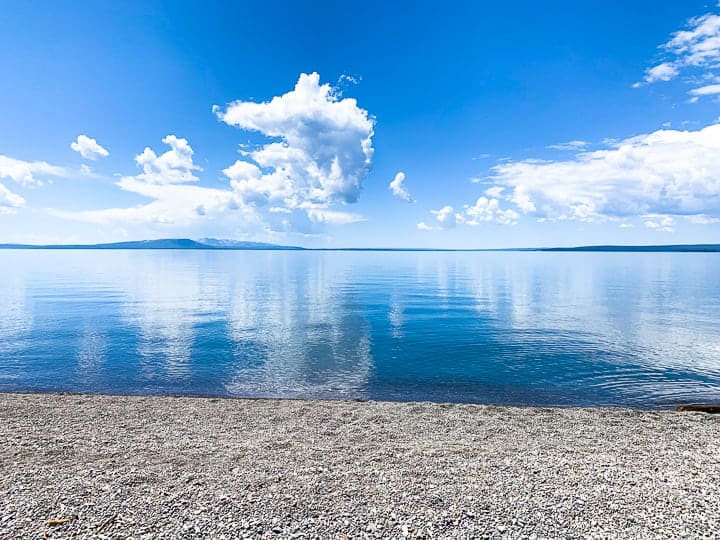 Yellowstone lake with the reflection of the sky in the water.