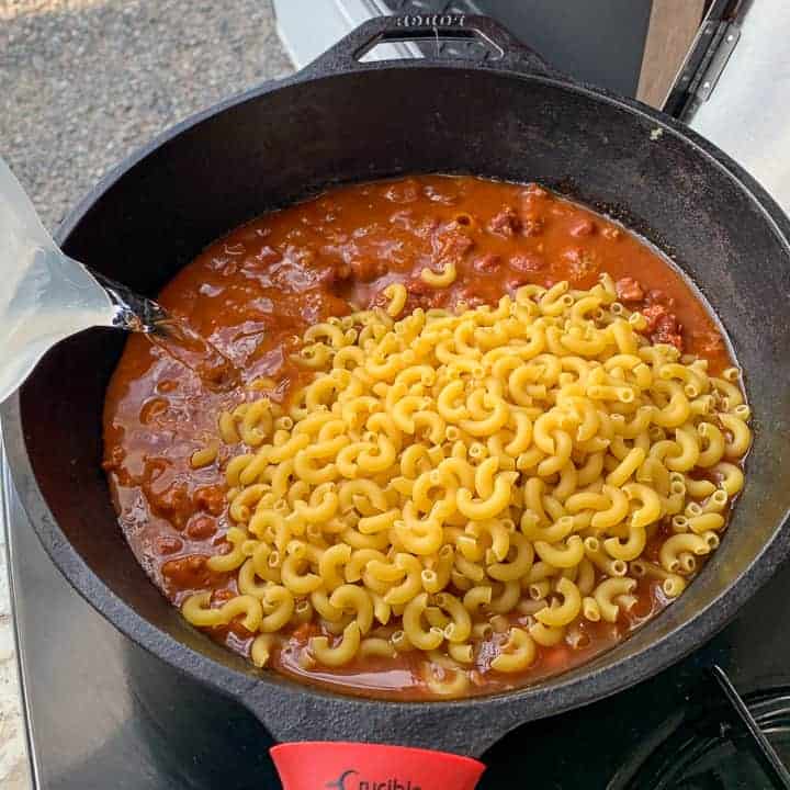 skillet of chili Mac being make in a campground