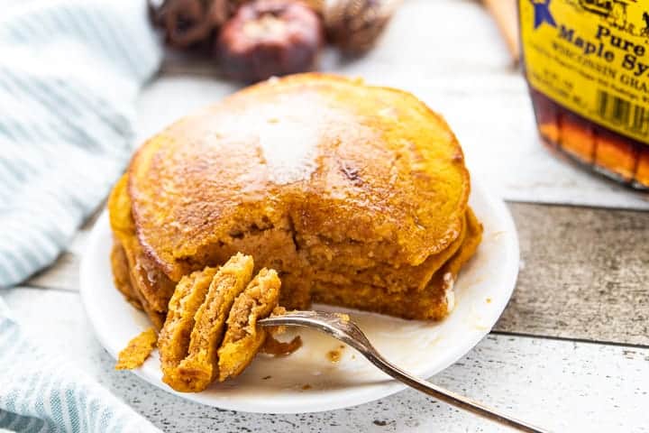 A plate of pumpkin Pancakes and Maple syrup