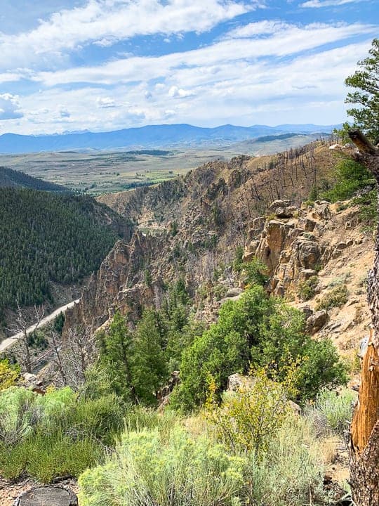 A view of Byers Canyon with mountains in the background.