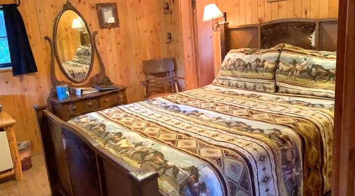 A bedroom in a log cabin at a family dude ranch in Colorado.