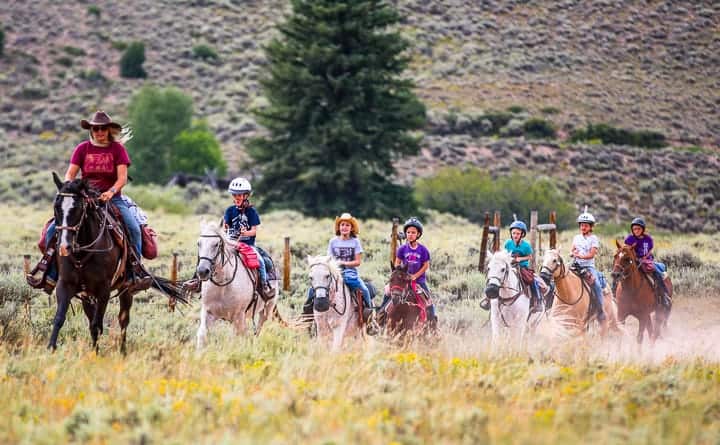 A group of people riding on the back of a horse