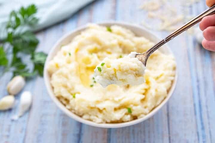 a bowl of mashed potatoes with butter