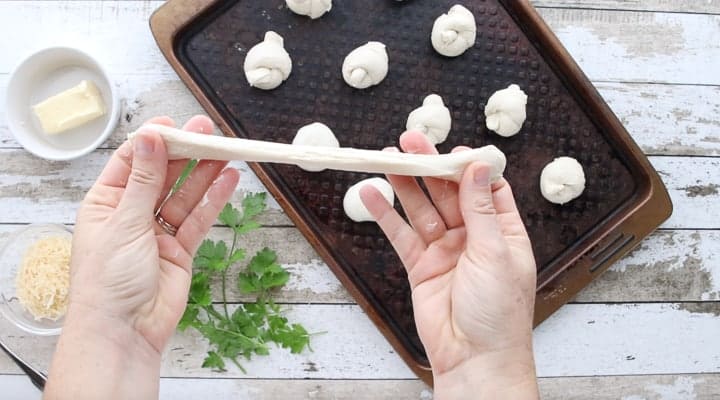 Dinner Roll dough being stretched