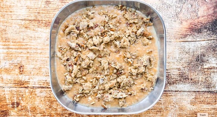 the wet and dry ingredients combined in a baking dish on a countertop. 