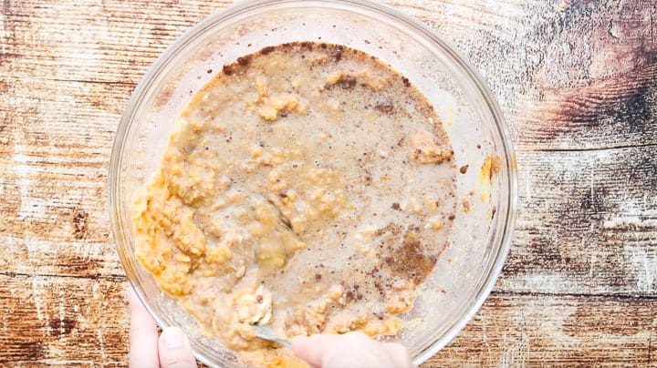 a glass bowl filled with all the ingredients being mixed.