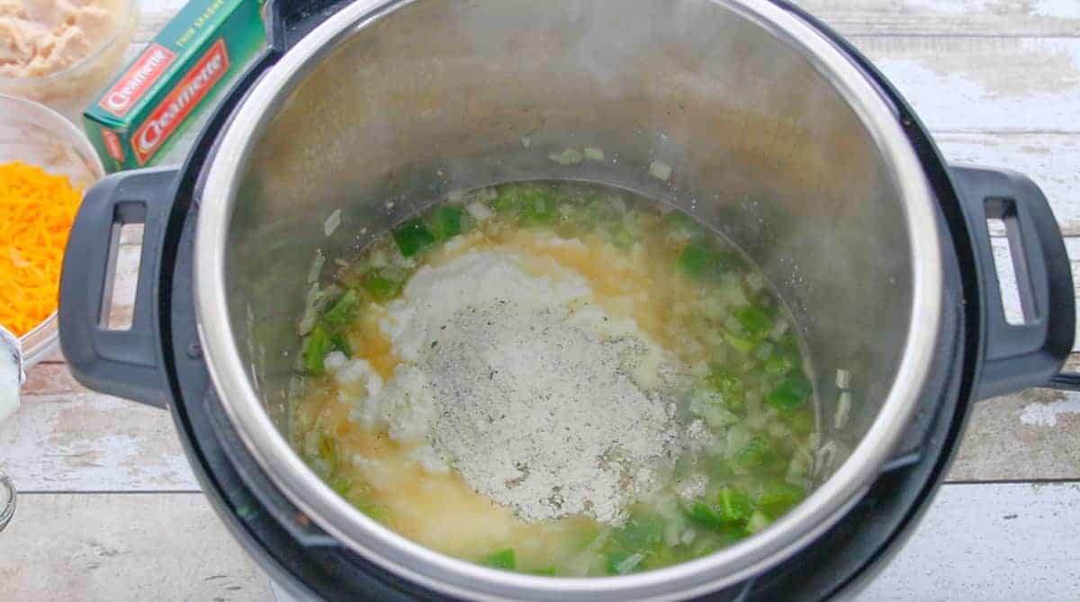 vegetables, chicken broth and ranch seasoning being sauteed  in an instant pot.