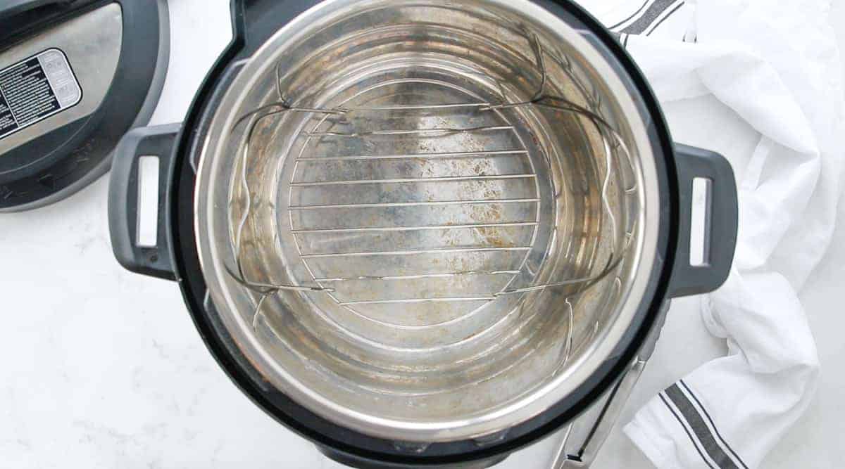 an empty instant pot with wire rack at the bottom of the pot.