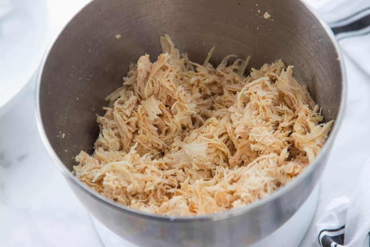 shredded chicken in a KitchenAid mixer bowl.
