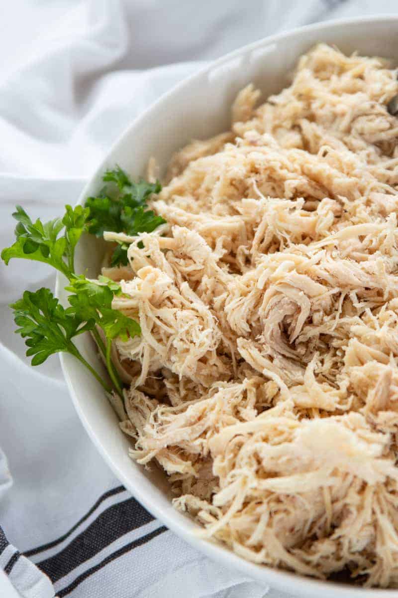 shredded chicken in a white serving bowl.