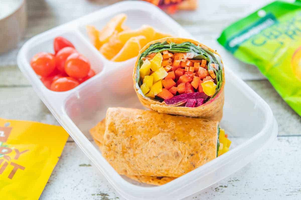 5 Veggie Packed Kid-Friendly Recipes showing a veggie wrap bento box on a countertop.