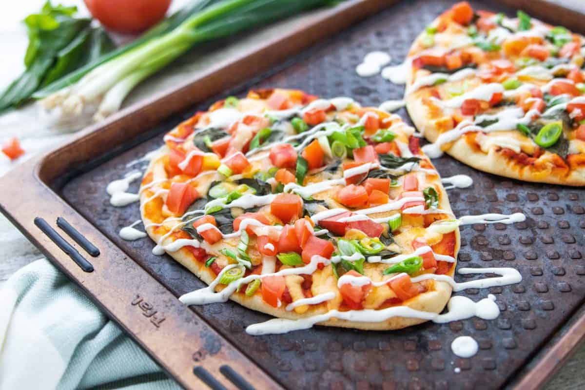 5 Veggie Packed Kid-Friendly Recipes showing a Naan pizza on a baking sheet.