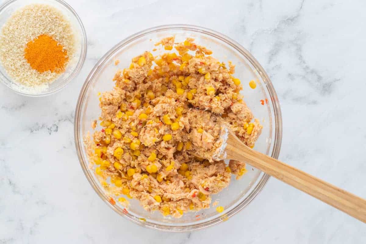 a bowl with corn, breadcrumbs, and other ingredients blended together