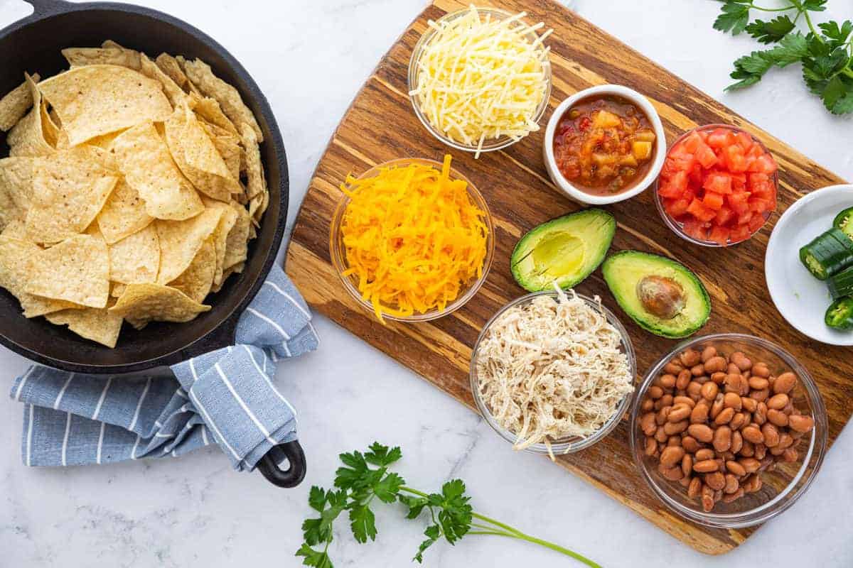 A bunch of food on a table to make Chicken Nachos