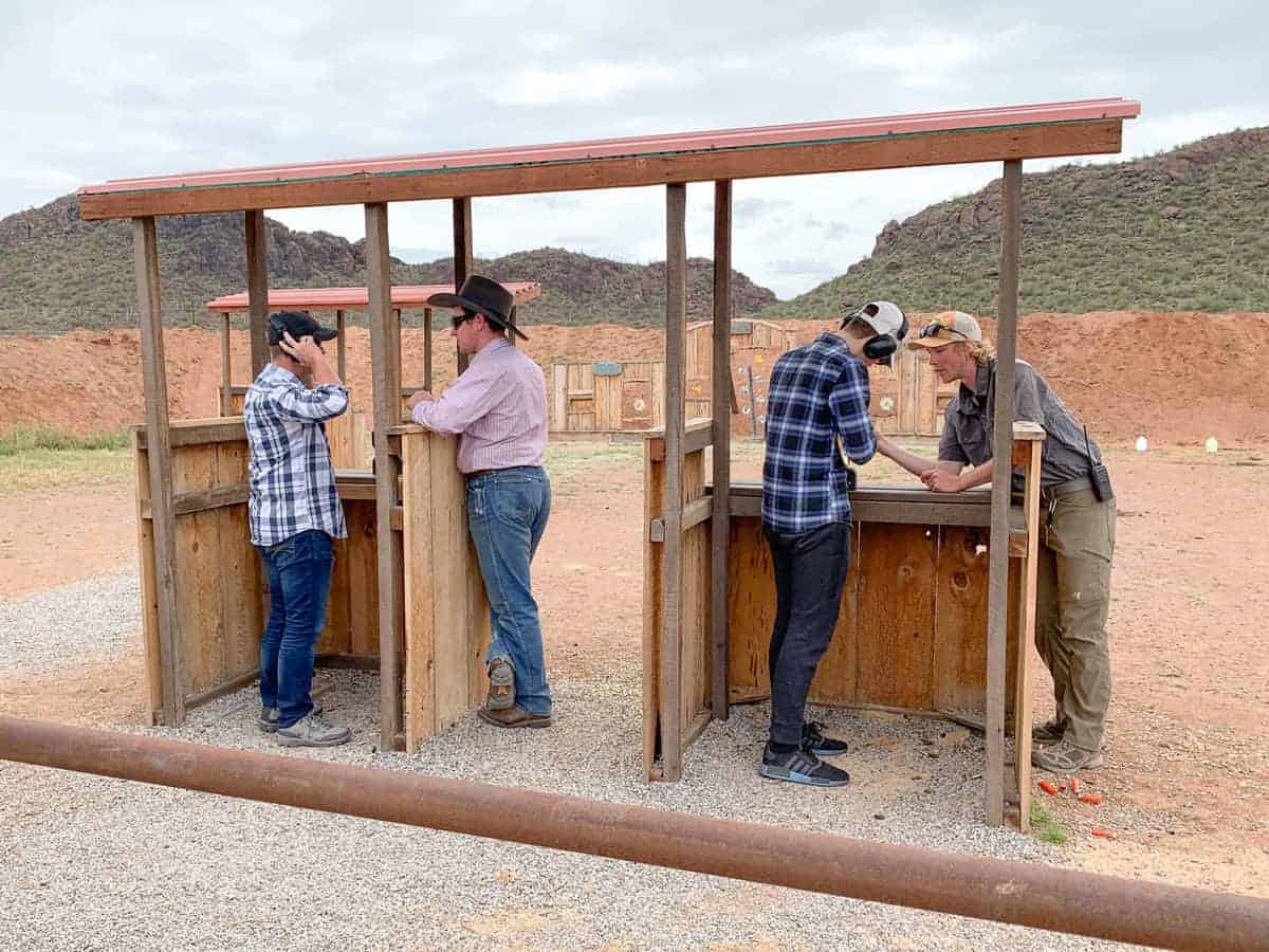 White Stallion Ranch, the Best All-Inclusive Resort in Arizona showing trained professionals teaching a father and son in the shooting range.