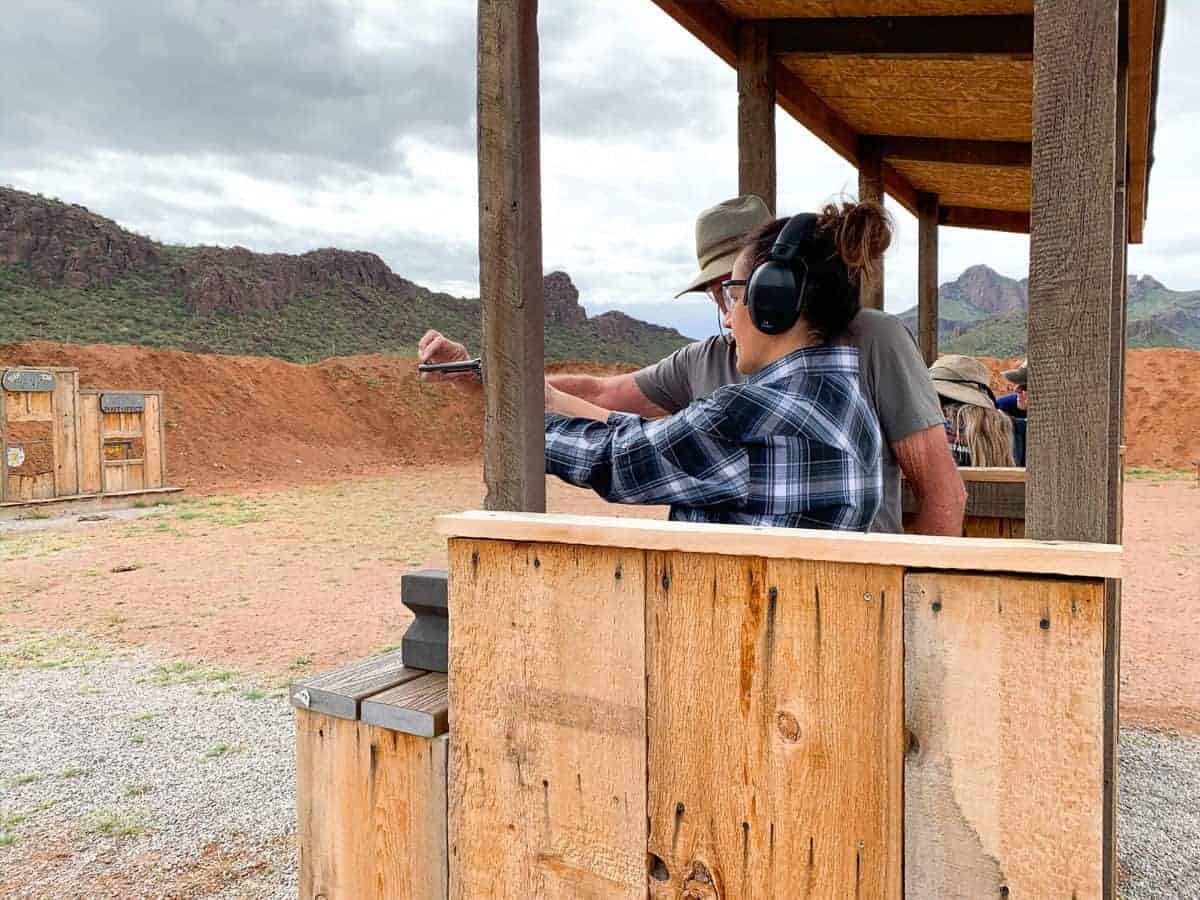 White Stallion Ranch, the Best All-Inclusive Resort in Arizona showing a professional teaching a ranch member in the shooting range.