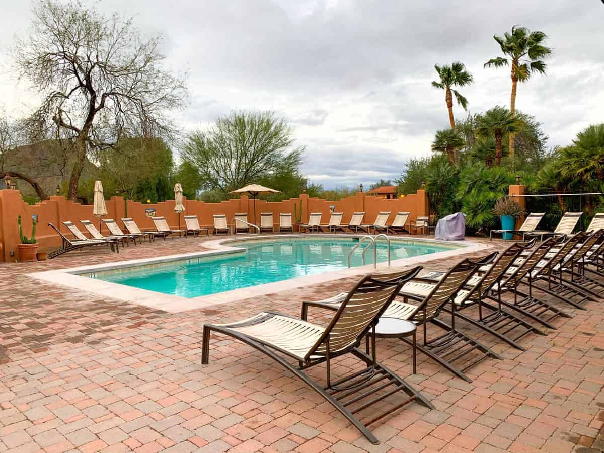 White Stallion Ranch, the Best All-Inclusive Resort in Arizona showing the heated pool with lounge chairs surrounding the pool area.