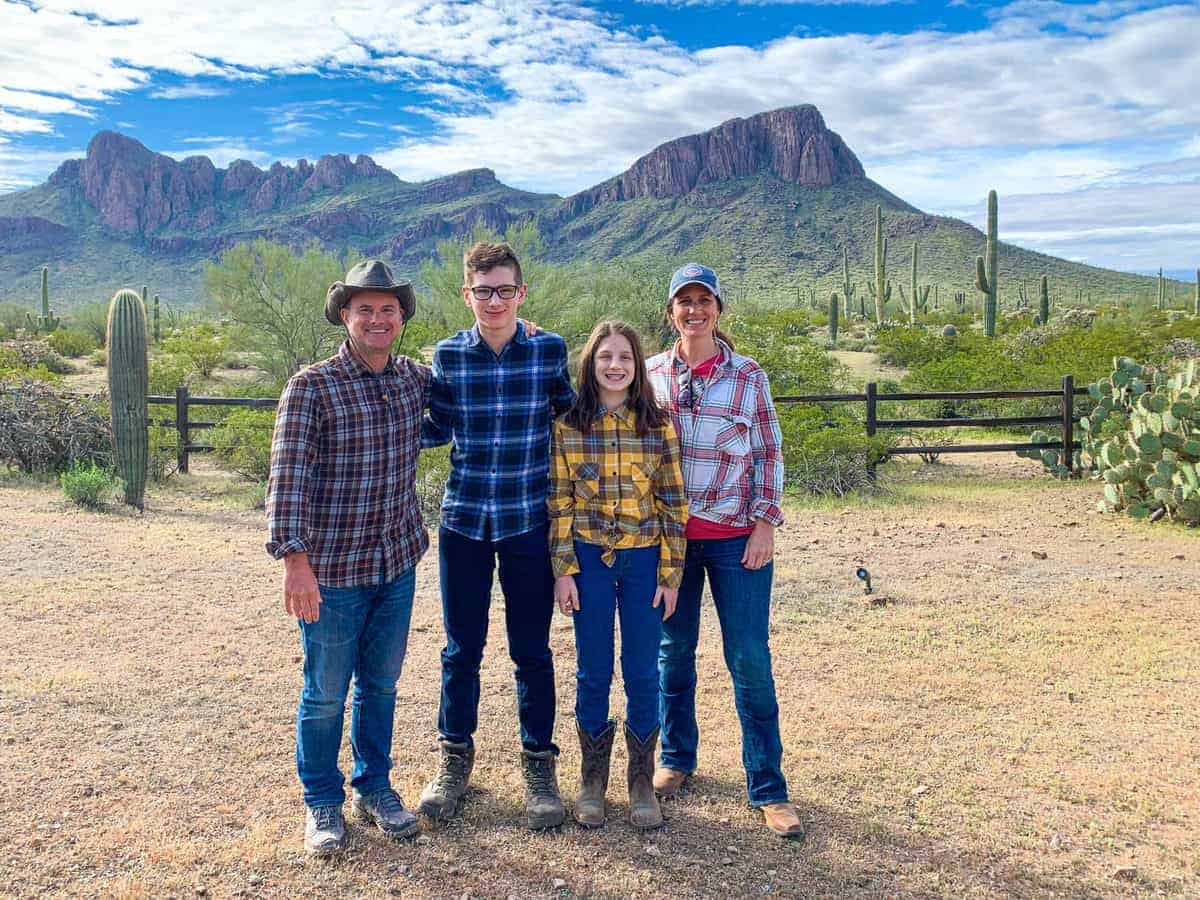 White Stallion Ranch, the Best All-Inclusive Resort in Arizona showing a family of four standing on the dude ranch.