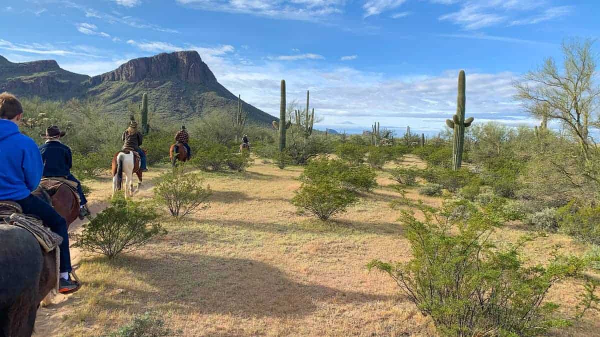 White Stallion Ranch, the Best All-Inclusive Resort in Arizona showing a family going on an early morning horseback ride.