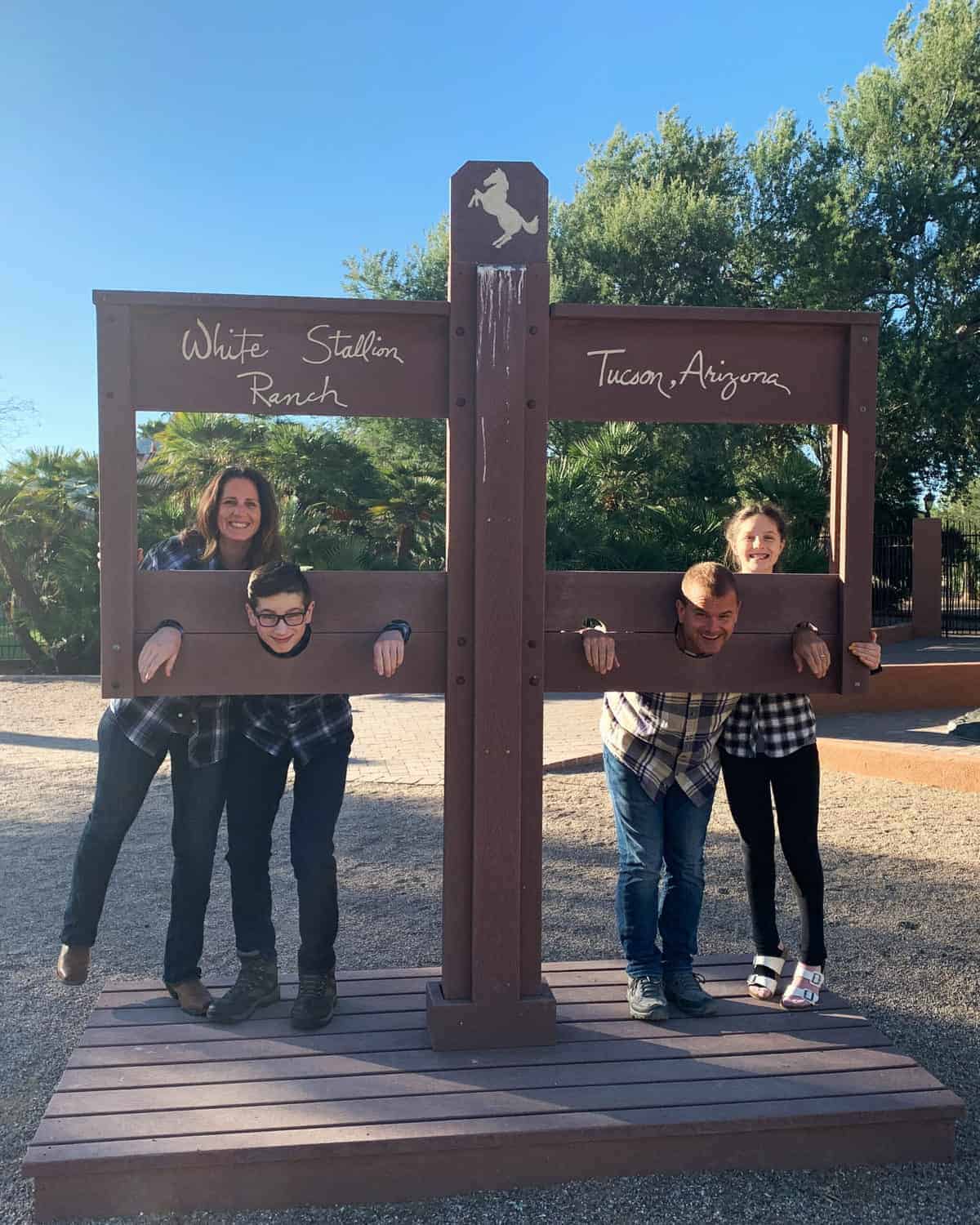 White Stallion Ranch, the Best All-Inclusive Resort in Arizona showing a family of four standing on the dude ranch.