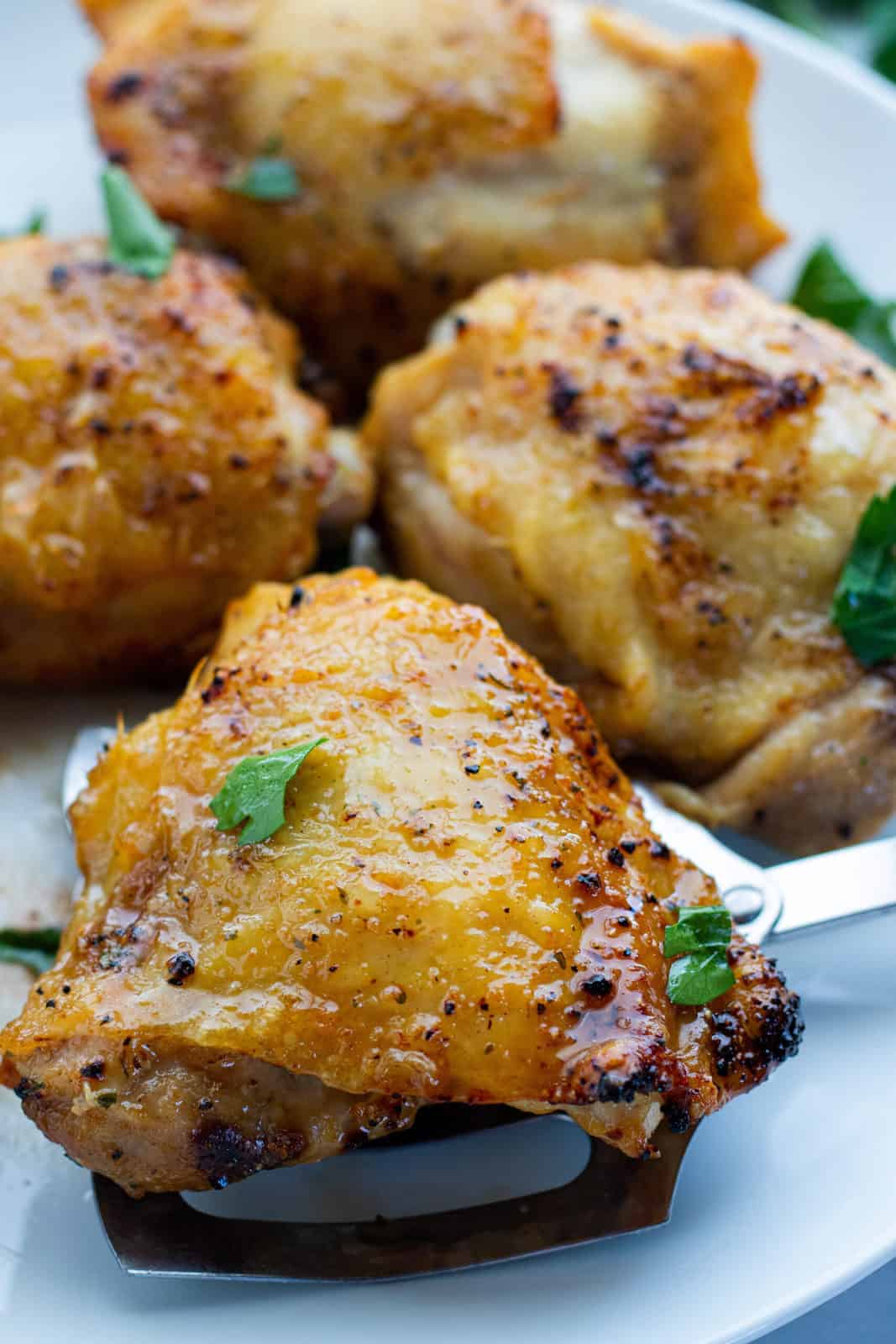 Crisp chicken thighs on a serving platter.