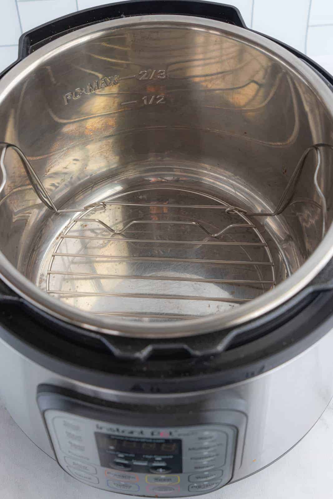 An instant pot with the lid off showing the clean inside.