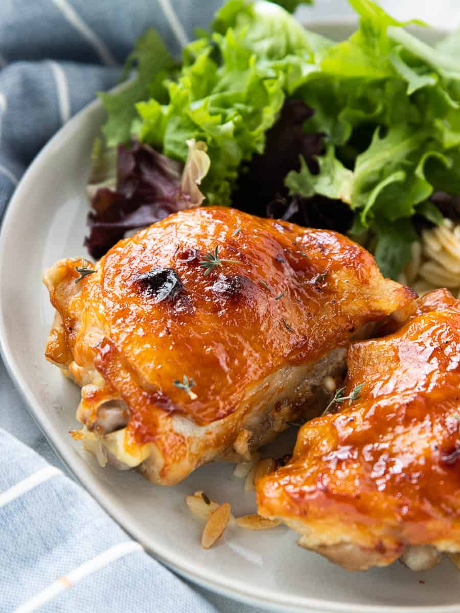 chicken thigh on a plate with a salad