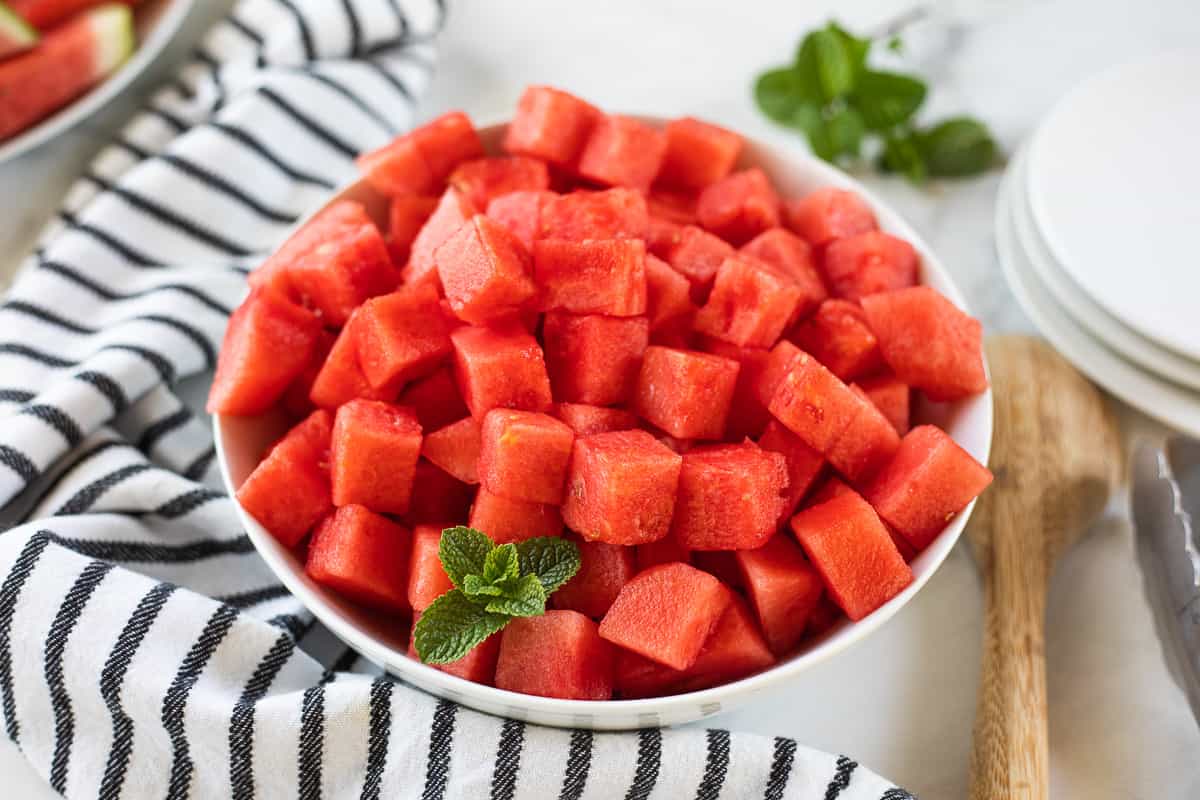 A bowl of diced watermelon.