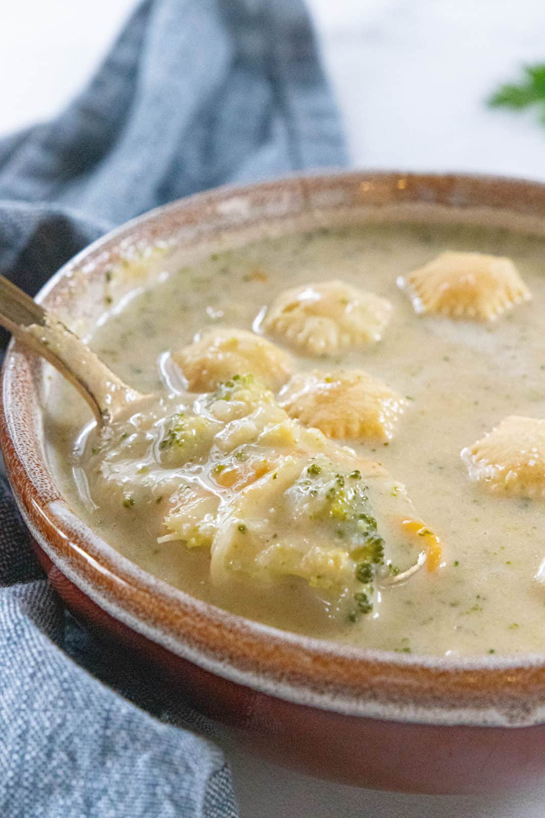 spoon in soup with crackers