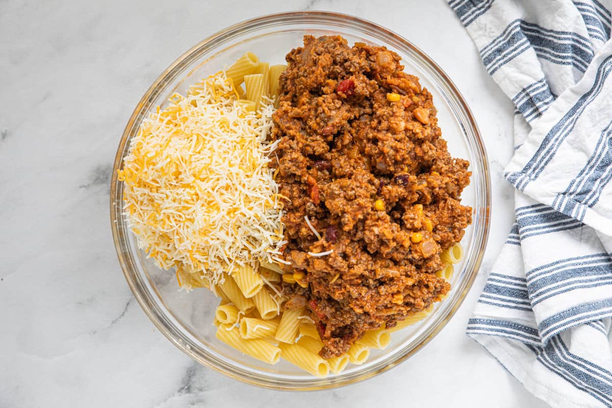 A plate of food with rice, with Taco and Pasta