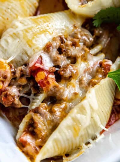 meat and cheese stuffed pasta shells in a baking pan