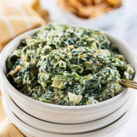 A bowl of dip with spinach