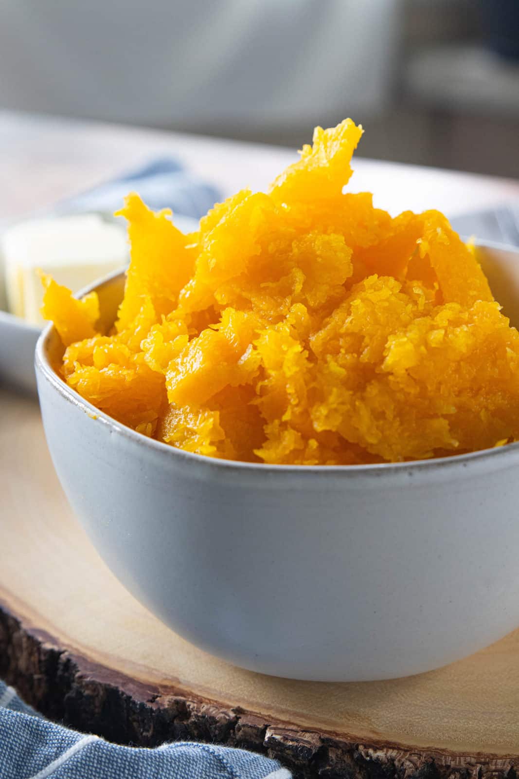 Steamed butternut squash in a white bowl. 