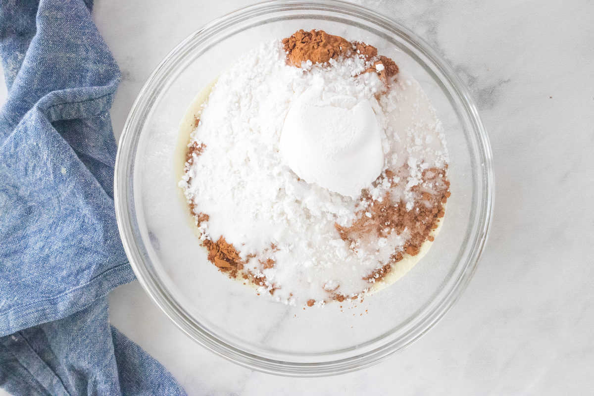 powdered milk, powdered sugar, sugar and cocoa powder in bowl