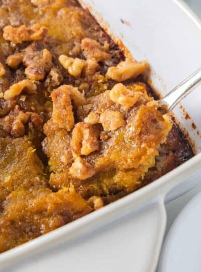 a close up of butternut squash casserole with a spoon