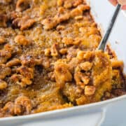 a close up of butternut squash casserole with a spoon