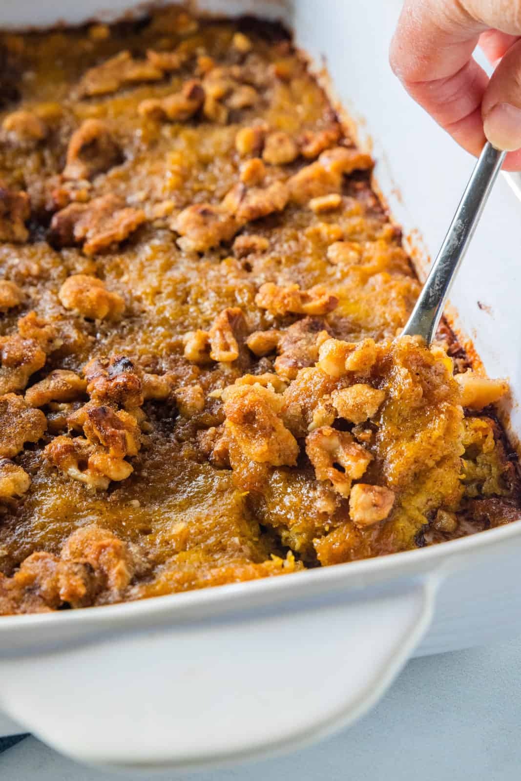 a close up of butternut squash casserole with a spoon