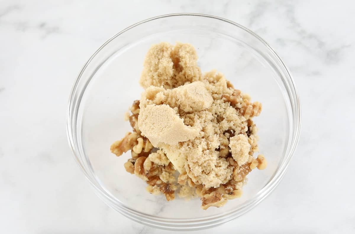 A small glass bowl filled with ingredients for crumb topping.