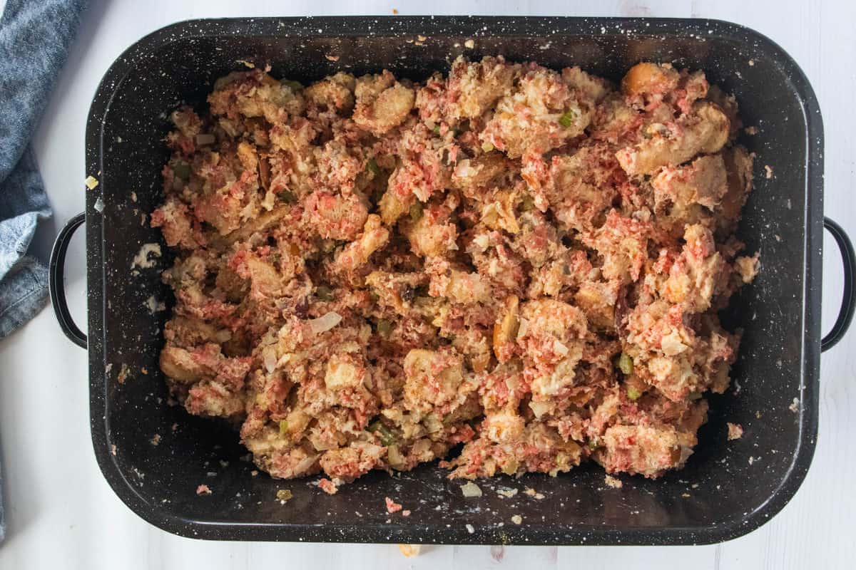 Ingredients for make-ahead stuffing mixed together in a large baking pan.