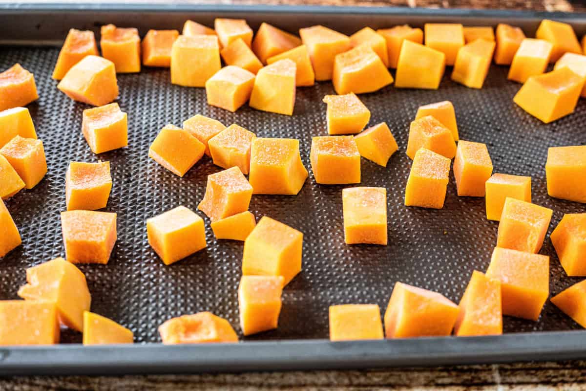 Chopped butternut squash on a baking sheet. 